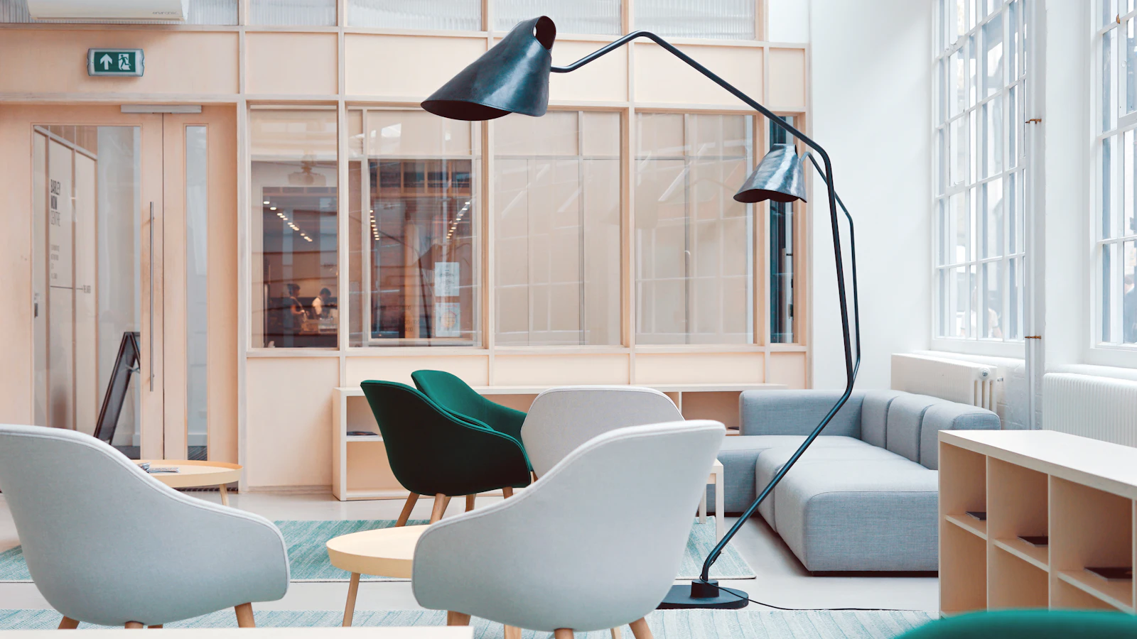 A bright shared office with desks and open walkways