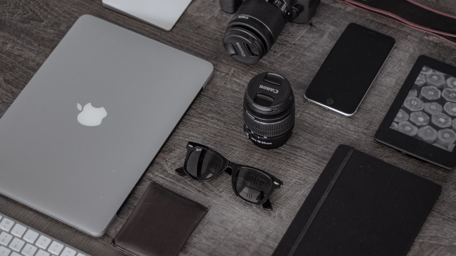 Phone, headphones, cables, and small electronics arranged for travel
